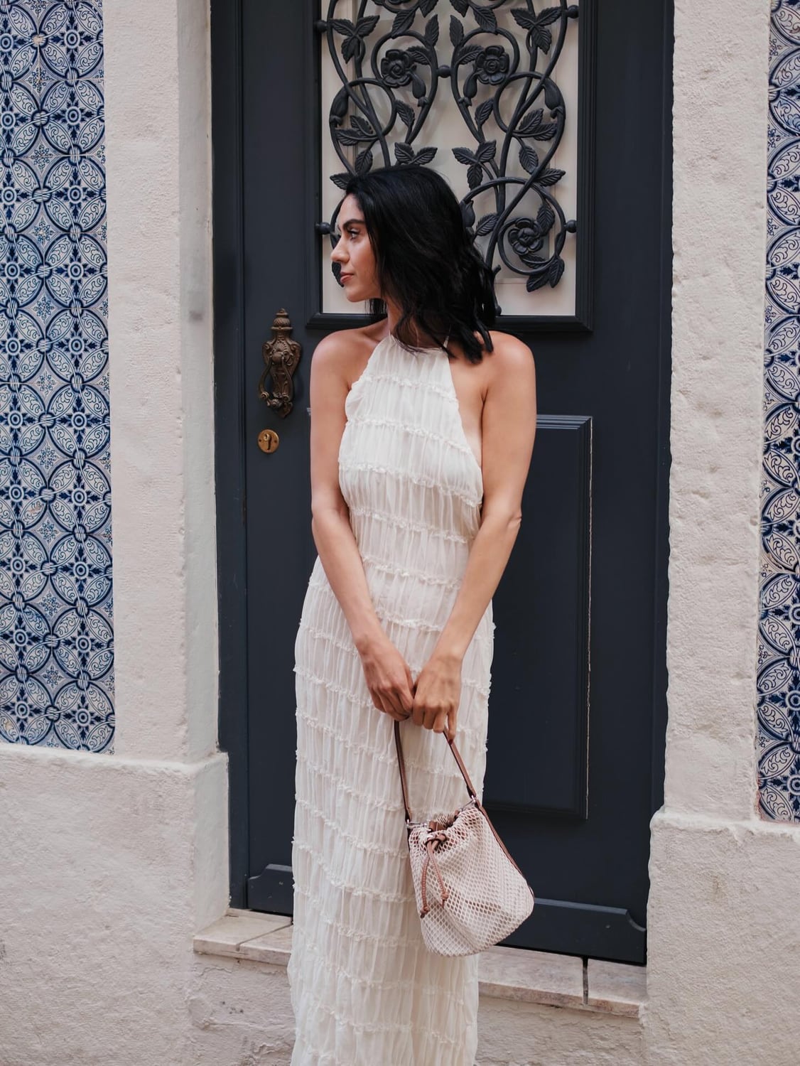 Kimia framed by patterned tile and a dark Lisbon doorway
