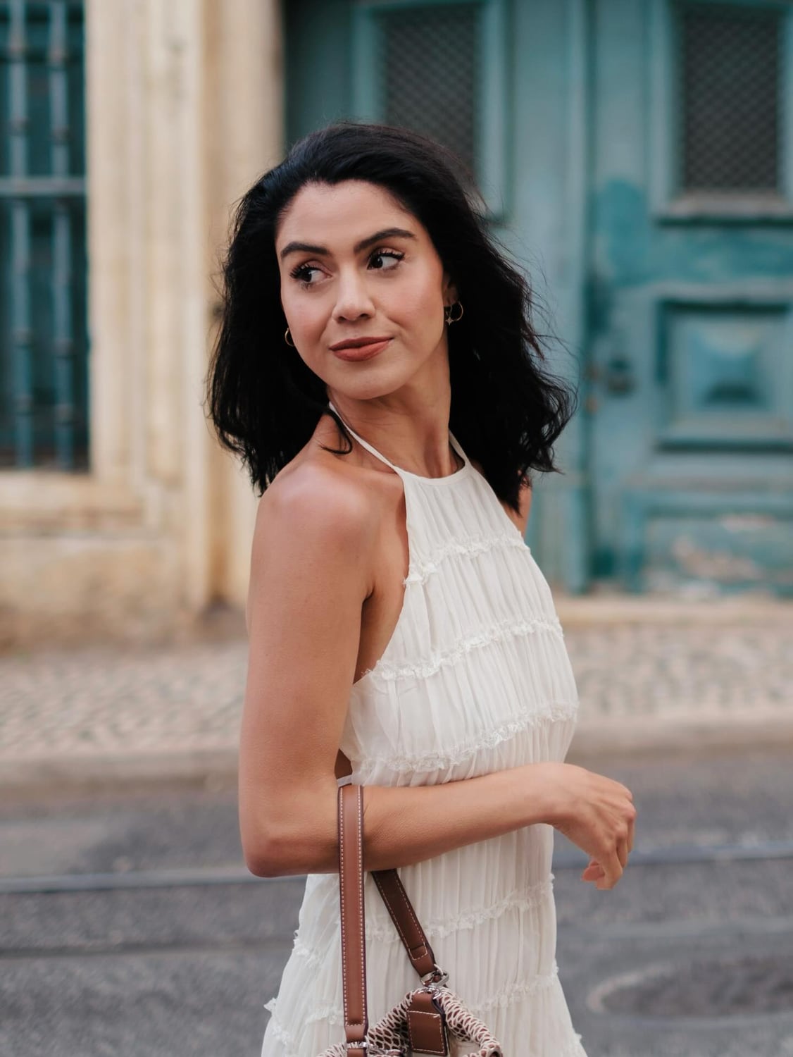 Close street portrait of Kimia in a white dress