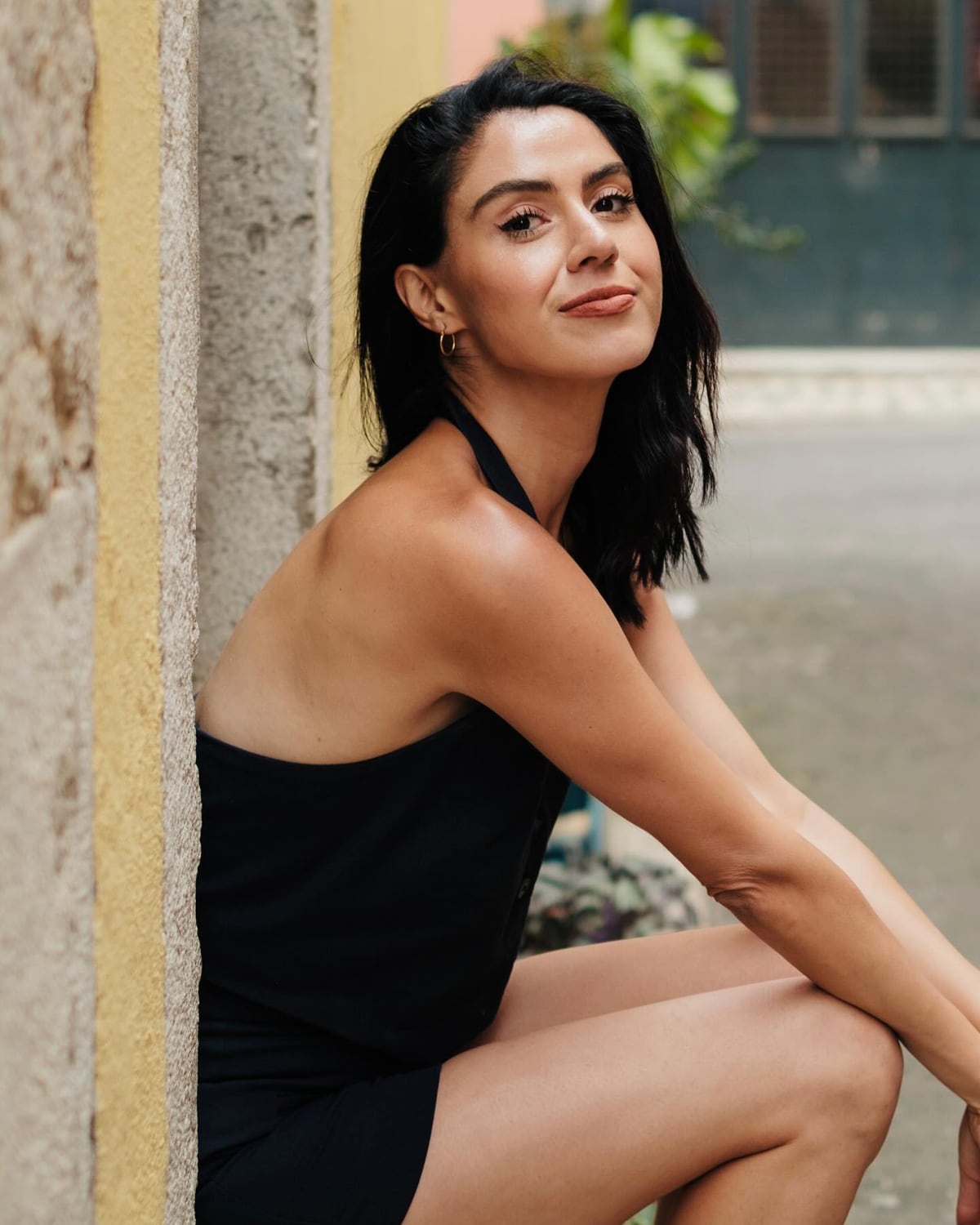 Seated portrait of Kimia in a black summer outfit