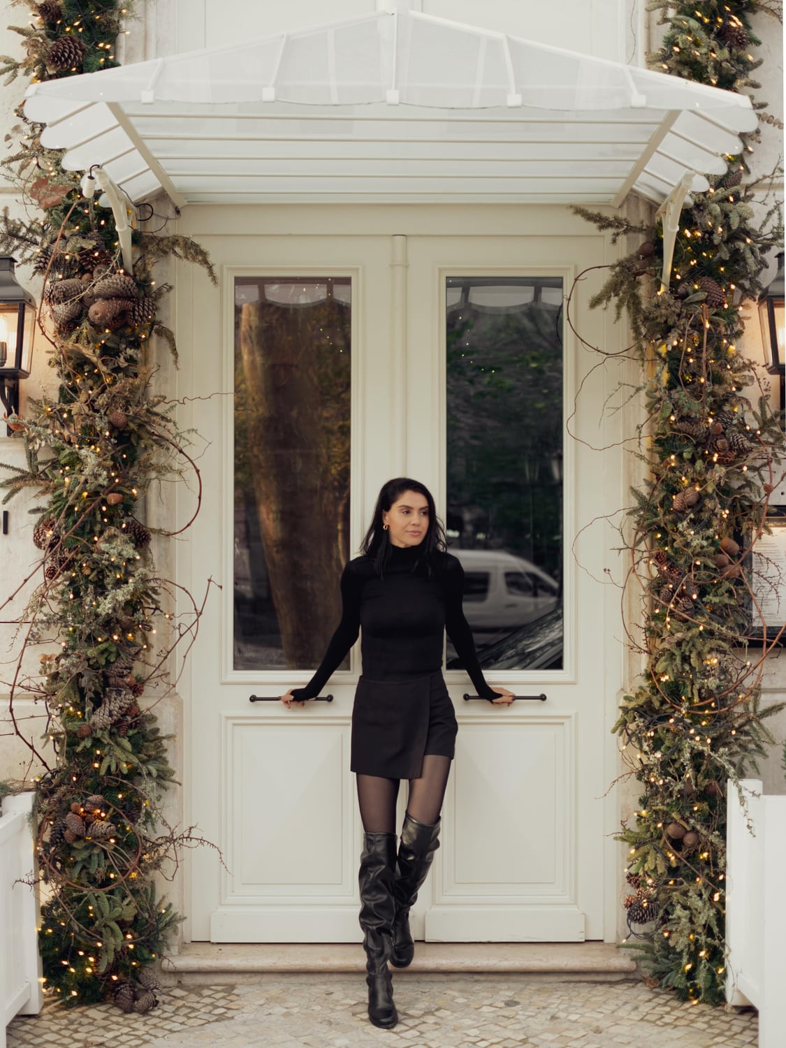 Kimia standing outside a flower-trimmed Lisbon storefront
